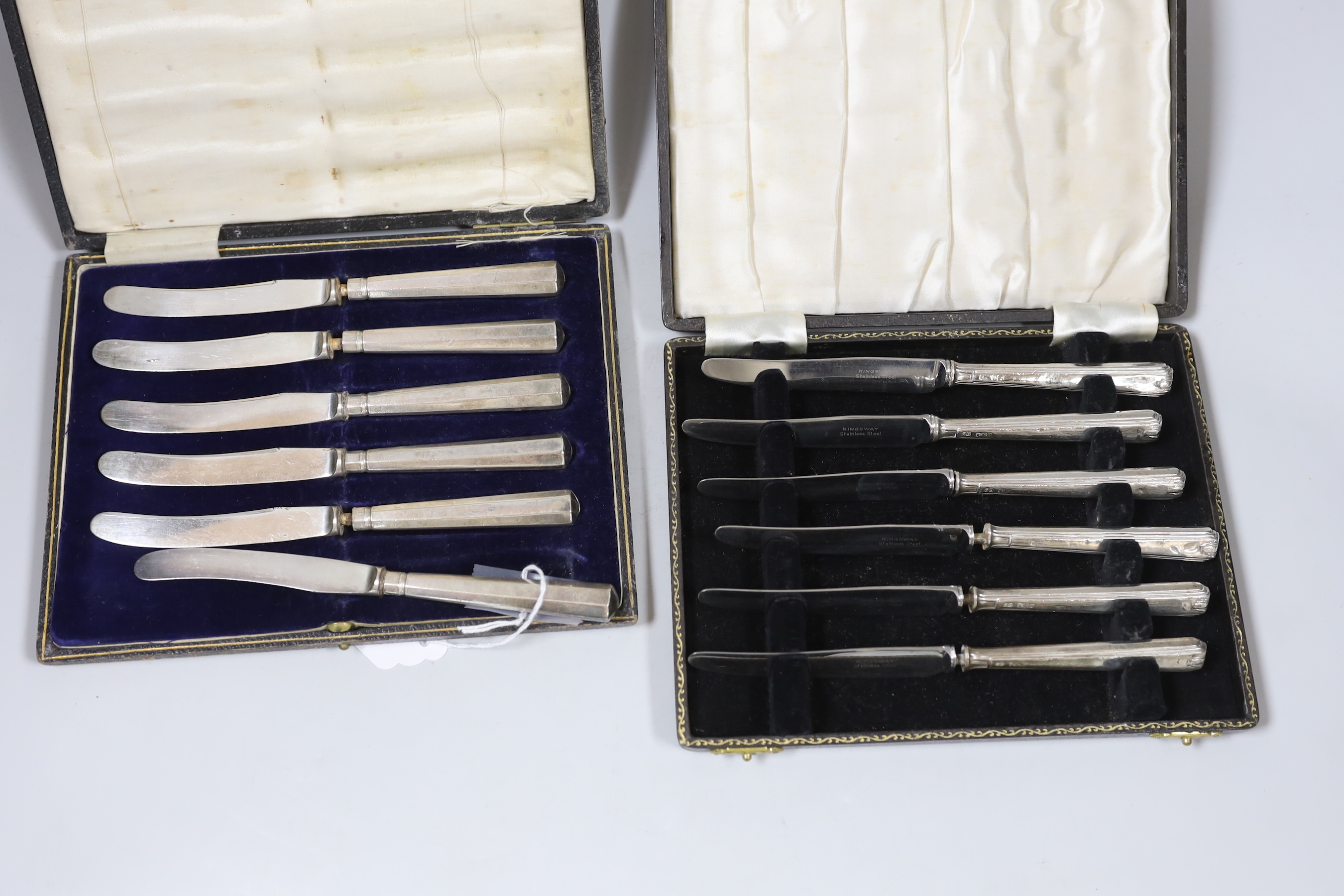 Two cased sets of six silver handled cake knives and cased plated nutcracker set.